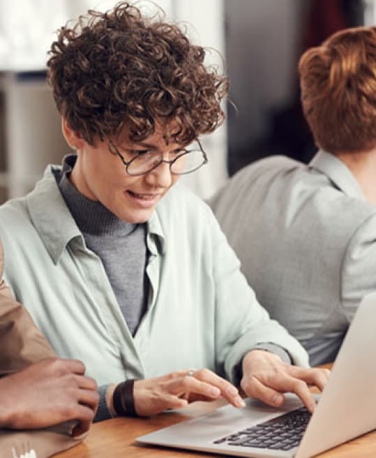 A student with a laptop in a library